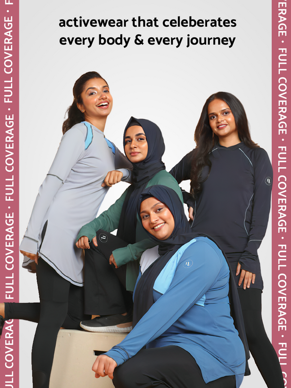 Models posing together wearing modest gym wear t-shirts.